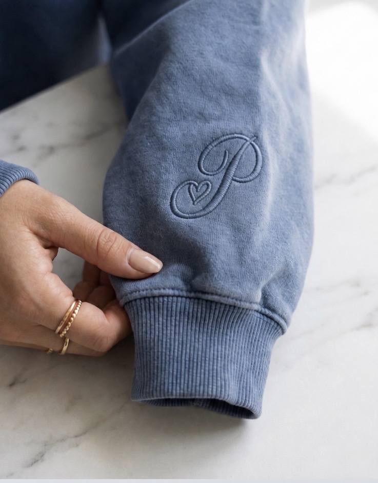 Tonal cursive P and heart embroidery on the Pending hoodie sleeve cuff
